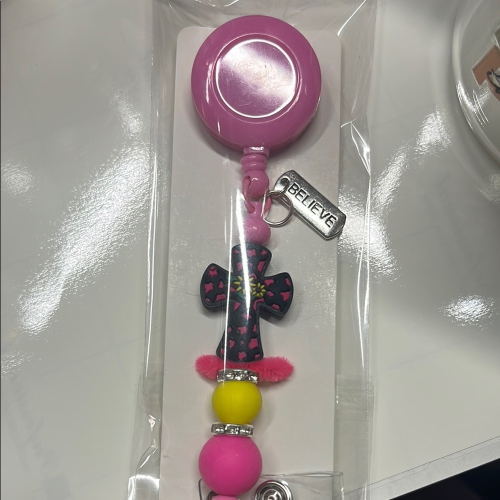 Pink and Yellow badge Accessory with Cross and Believe Charm